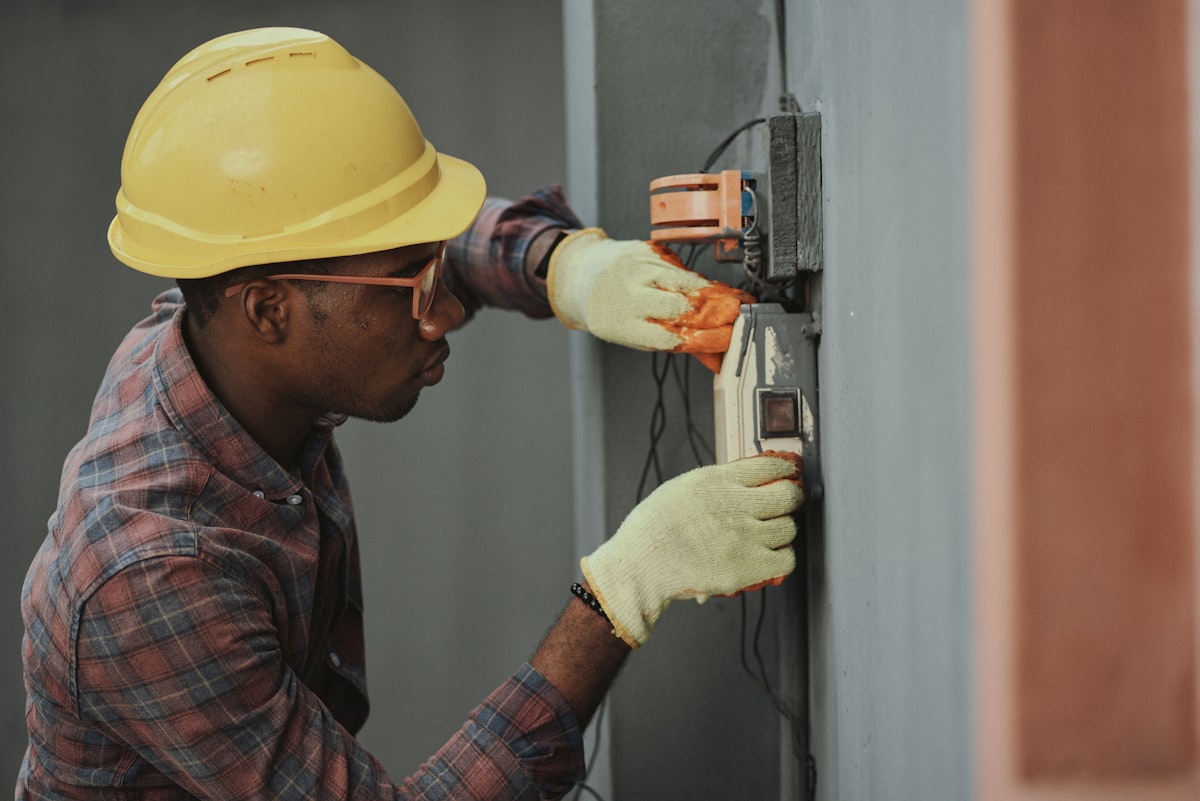 A professional tradesman carefully working on a service call